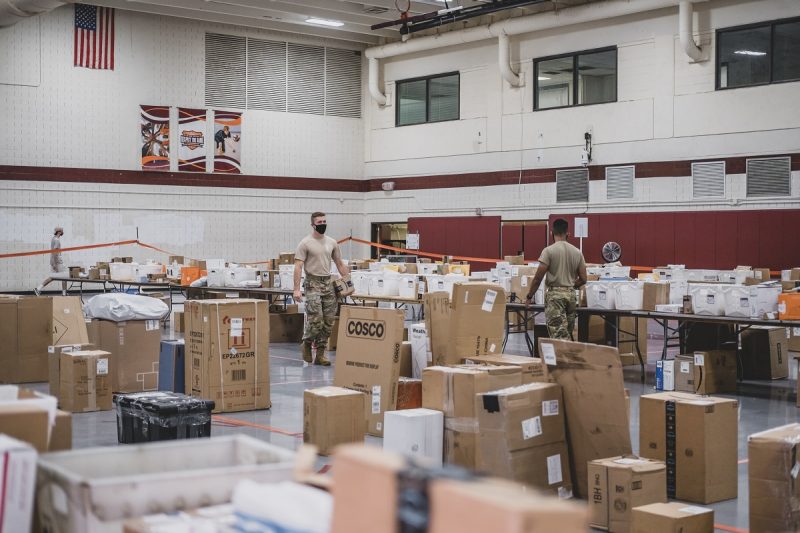 two cadets surrounded by boxes in War Memorial Gym